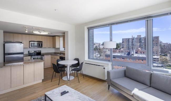 a living room with a couch, table and chairs