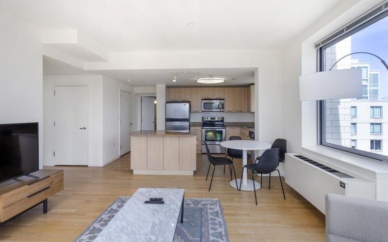 a living room with a table, chairs and a tv